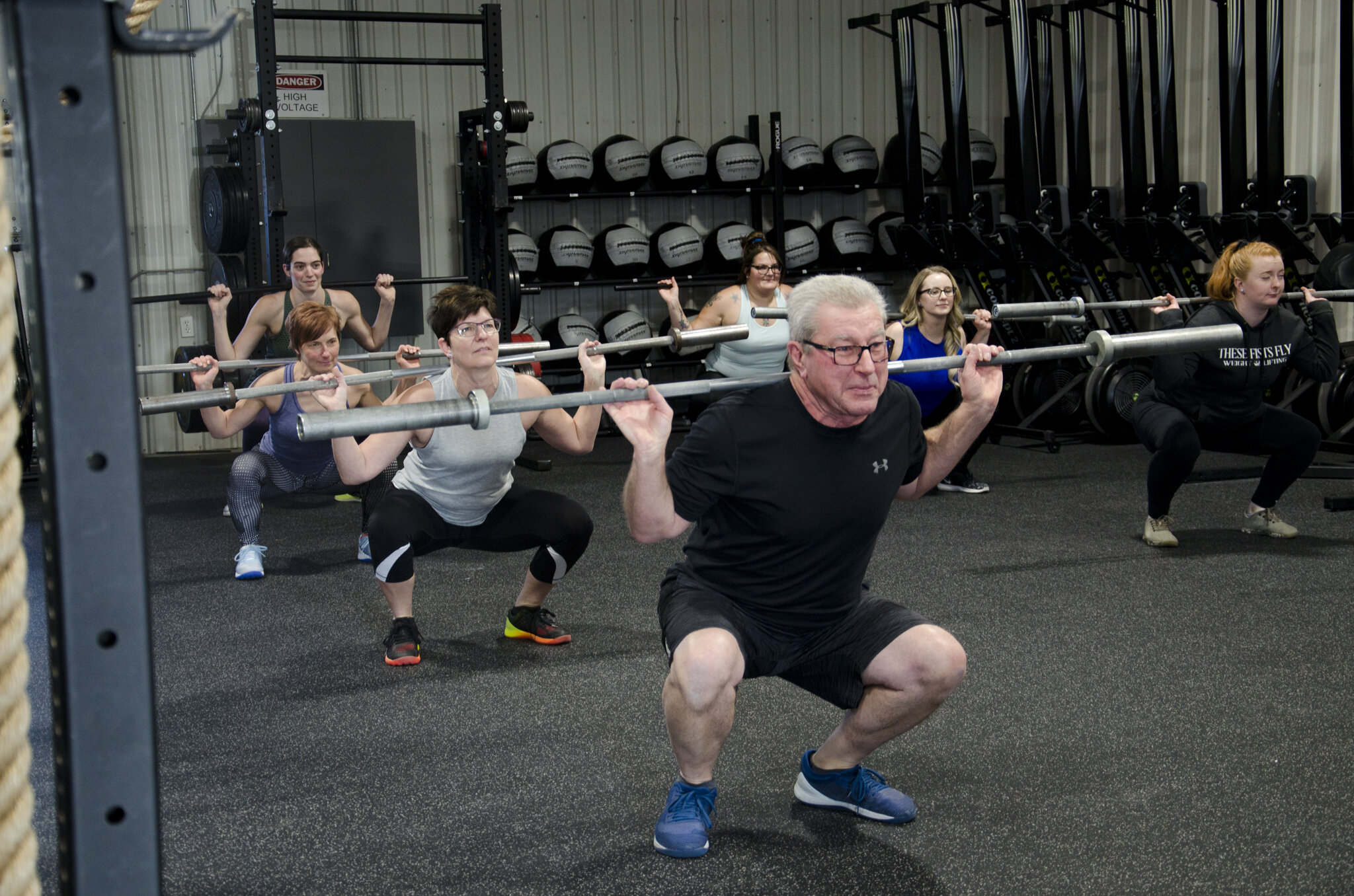 An athlete lifting with a coach at Ignite Fitness